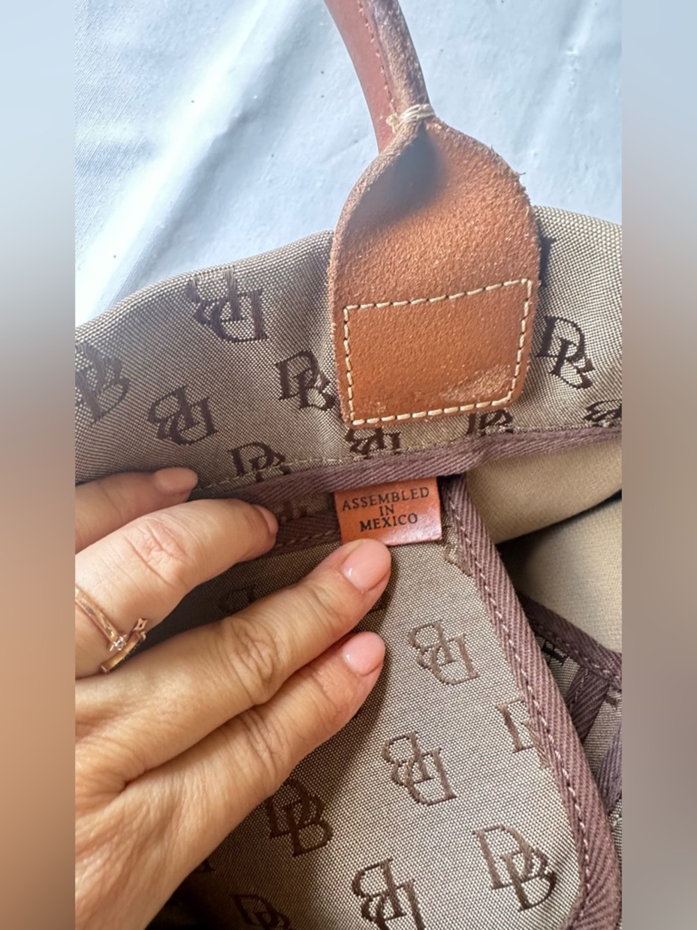 Dooney & Bourke monogram canvas and leather drawstring tote bag. - Picture 8 of 11